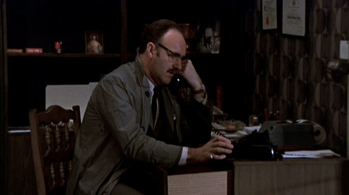 the-conversation_gene-hackman_raincoat-mid-desk-6555550