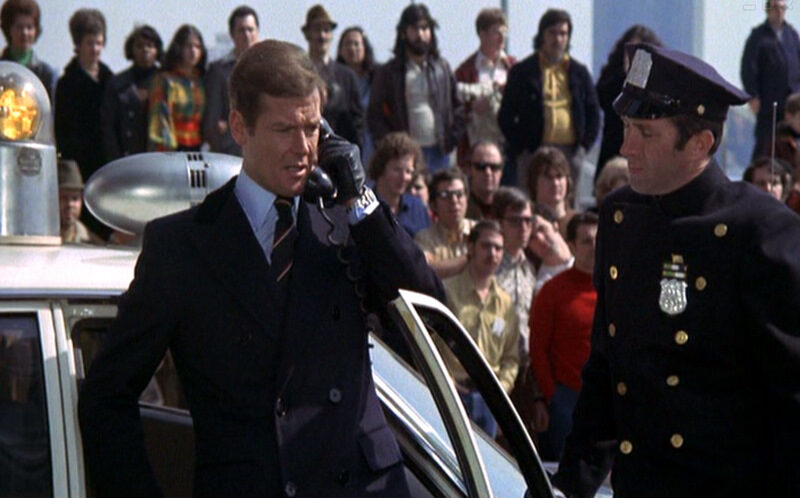 live-and-let-die_roger-moore_chesterfield-coat_police-car-mid-bmp-8055788